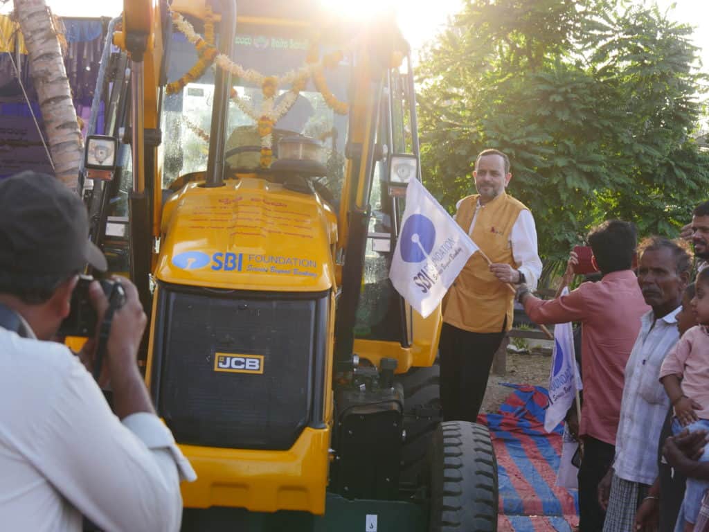 Shri Lalit Mohan takes a ride on the new JCB