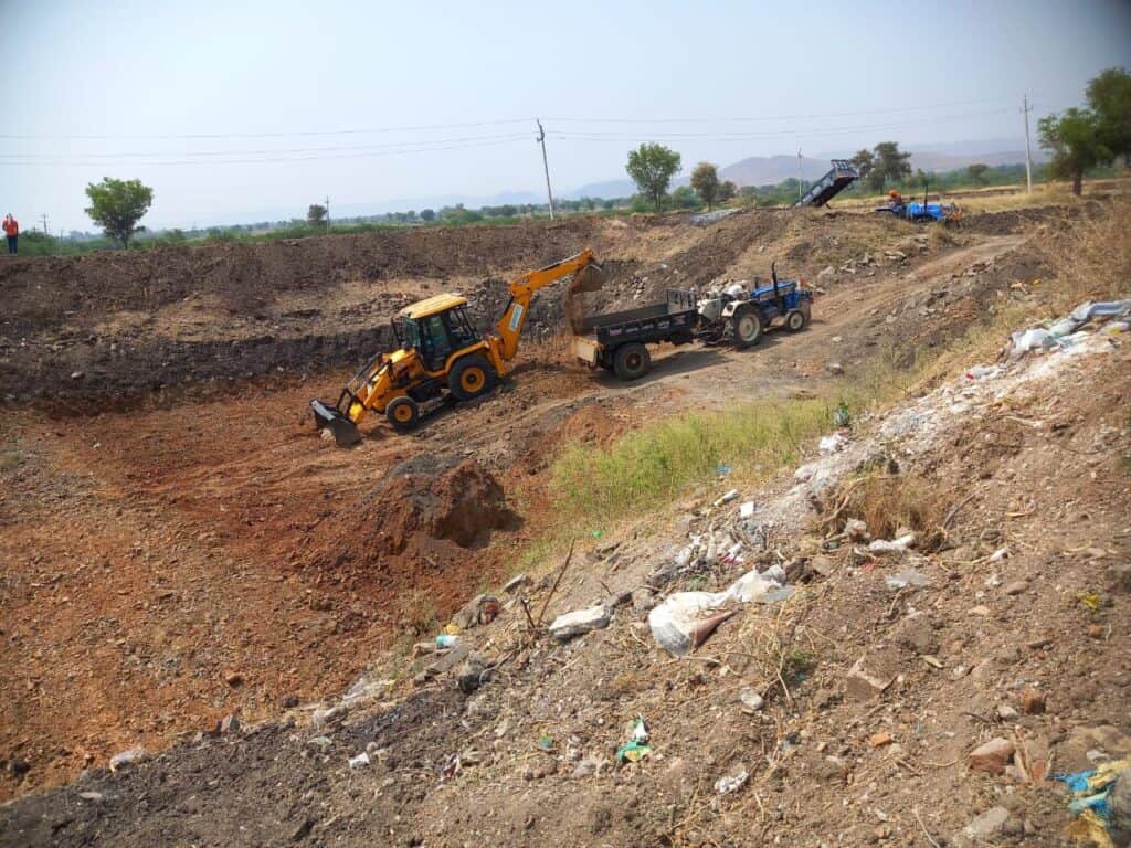 Cleaning a large village pond.